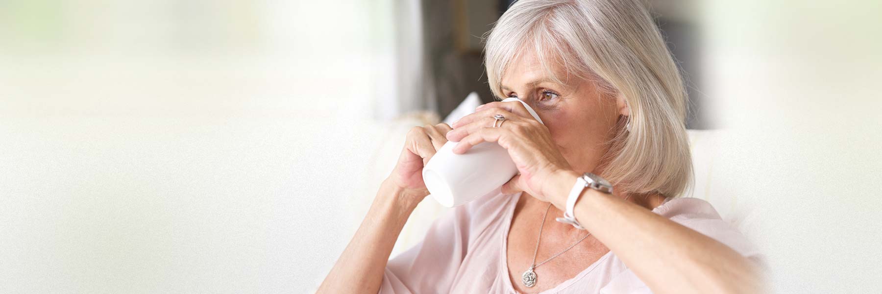 elderly-lady-on-couch-drinking