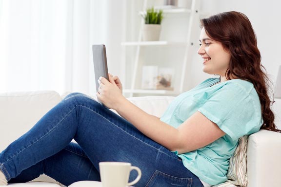 girl-on-tablet-on-sofa-reading-01